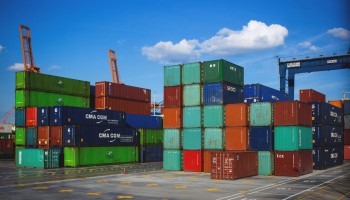 What is the difference between Cross Stuffing and Transshipment in Global Logistics?